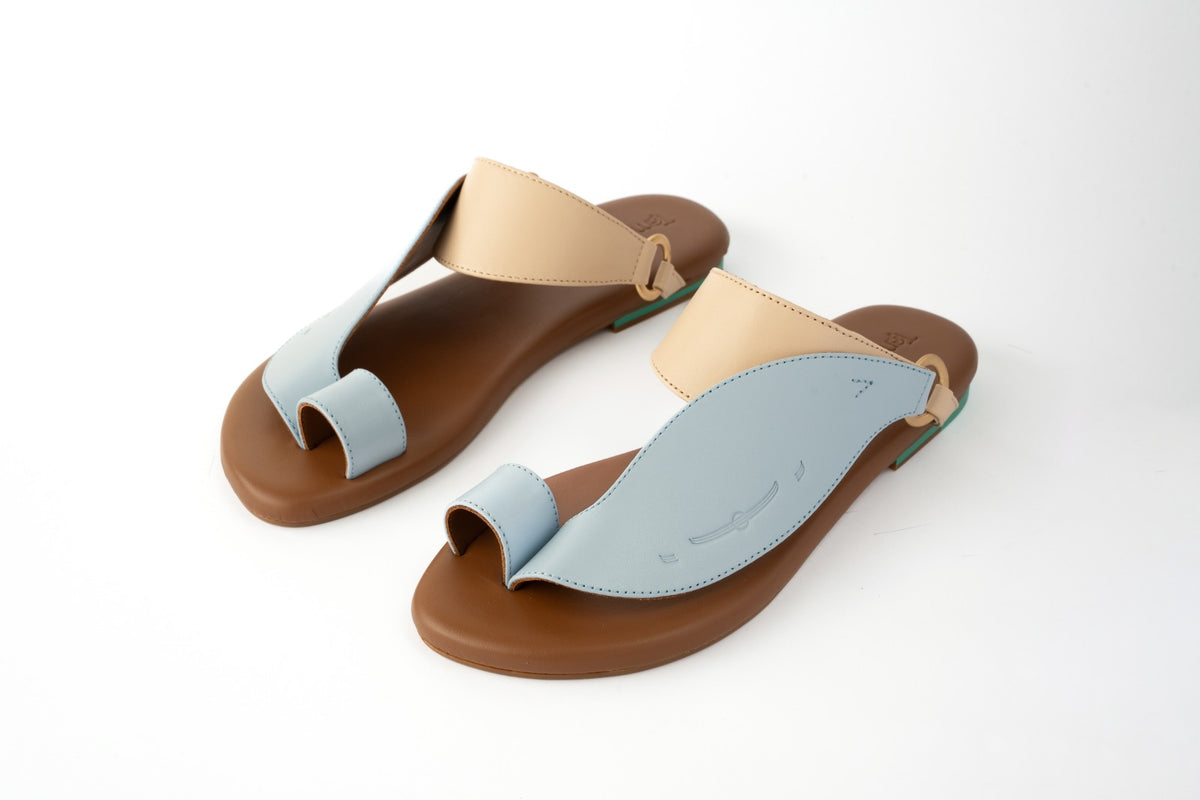Side View of Talaheeq Women Sandals|Cow Leather Sandals For Women Stylish Arabic Flat Sandals|Talaheeq cow leather mix of natural and light blue color|Iron matte gold ring of Talaheeq cow leather|Upper View of Talaheeq Sandals For women|Highlight Informat